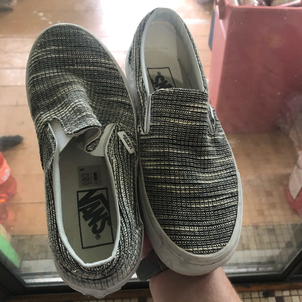 Grey, silver, white, and black Vans slip-on shoes